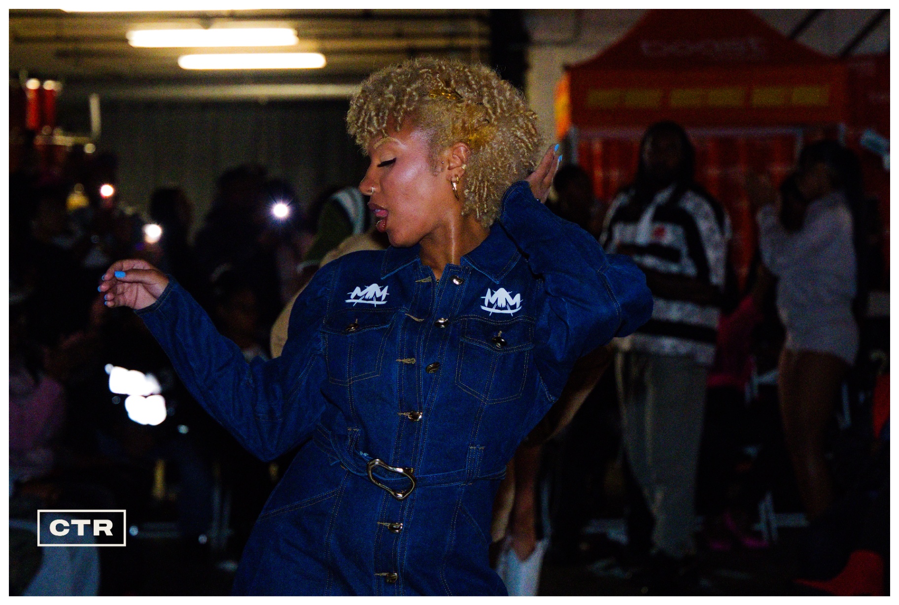 Runway — denim jumpsuit, blonde curls